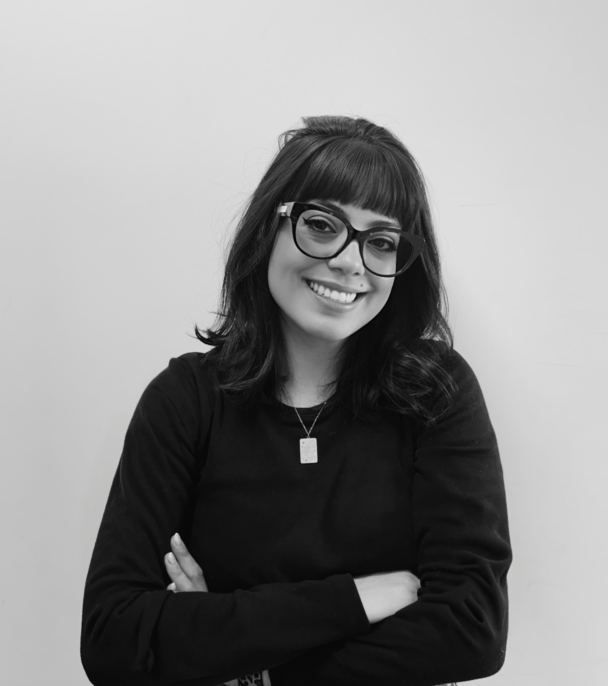 Nicole Farinello smiling, arms crossed